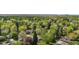 A bird's eye view shows mature trees and the surrounding neighborhood at 3194 S Milwaukee St, Denver, CO 80210