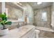 Stylish bathroom with a marble countertop, modern sink, and tiled walls and bathtub at 3194 S Milwaukee St, Denver, CO 80210