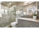 Updated bathroom features stylish vanity, stone tile shower with glass enclosure, and modern fixtures at 3194 S Milwaukee St, Denver, CO 80210