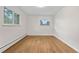 Bright bedroom with hardwood floors and abundant natural light from two large windows at 3194 S Milwaukee St, Denver, CO 80210