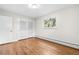 Bright bedroom featuring hardwood floors, a large window, and ample closet space at 3194 S Milwaukee St, Denver, CO 80210