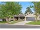 Charming single Gathering home boasts a manicured lawn, attached garage, and welcoming front porch at 3194 S Milwaukee St, Denver, CO 80210