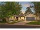 Charming single Gathering home boasts a manicured lawn, attached garage, and welcoming front porch at 3194 S Milwaukee St, Denver, CO 80210