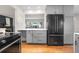 Kitchen with stainless steel appliances, grey cabinets and countertops at 3194 S Milwaukee St, Denver, CO 80210