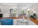 Bright living room featuring hardwood floors, modern lighting, and open floor plan at 3194 S Milwaukee St, Denver, CO 80210
