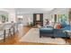 Open concept living room featuring hardwood floors, fireplace, and abundant natural light at 3194 S Milwaukee St, Denver, CO 80210