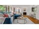 Beautiful living room featuring a comfortable blue sofa, hardwood floors, and natural light at 3194 S Milwaukee St, Denver, CO 80210