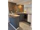 Stylish wet bar boasts stone accents, modern cabinetry, and a built-in wine fridge at 3194 S Milwaukee St, Denver, CO 80210
