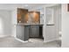 Charming wet bar includes stone tile, modern cabinetry, and a built-in wine fridge at 3194 S Milwaukee St, Denver, CO 80210