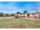 Spacious backyard with a red wooden deck and a green lawn; mountains are visible at 5128 S Greenwood Dr, Evergreen, CO 80439