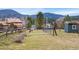 Picturesque backyard setting with deer grazing peacefully near a shed and fenced area at 5128 S Greenwood Dr, Evergreen, CO 80439