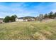 Expansive backyard with a green lawn, utility sheds, and greenery, great for outdoor activities at 5128 S Greenwood Dr, Evergreen, CO 80439