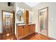 Bathroom with double vanities, wood cabinets, and a shower, featuring neutral tones at 5128 S Greenwood Dr, Evergreen, CO 80439