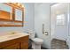 Bathroom featuring a single vanity with wood cabinets, a toilet, and a glass enclosed shower at 5128 S Greenwood Dr, Evergreen, CO 80439