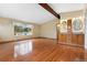 Bright, empty room with wooden floors, a large window, and built in vanity at 5128 S Greenwood Dr, Evergreen, CO 80439