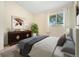 Bedroom featuring a comfortable bed with a plant, a dresser, and lots of natural light at 5128 S Greenwood Dr, Evergreen, CO 80439