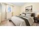 Cozy bedroom featuring a comfortable bed, a bedside table, and lots of natural light at 5128 S Greenwood Dr, Evergreen, CO 80439