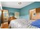 Bedroom featuring blue walls, a patterned bedspread, and a window view at 5128 S Greenwood Dr, Evergreen, CO 80439
