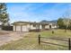 Spacious home featuring an attached two-car garage and a scenic mountain view backdrop at 5128 S Greenwood Dr, Evergreen, CO 80439