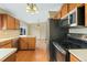 Well-lit kitchen with wooden cabinets, stainless steel appliances, and an adjacent dining area with mountain views at 5128 S Greenwood Dr, Evergreen, CO 80439