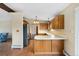 Well-lit kitchen with wooden cabinets, stainless steel appliances, and breakfast bar at 5128 S Greenwood Dr, Evergreen, CO 80439