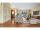Bright living room featuring hardwood floors, a large window, and neutral-toned furniture at 5128 S Greenwood Dr, Evergreen, CO 80439