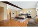 Spacious bedroom featuring a vaulted ceiling, wooden beam, and a seating area for relaxation at 5128 S Greenwood Dr, Evergreen, CO 80439