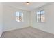 Spacious bedroom with neutral carpeting and large windows offering mountain views at 15566 W Beloit Ave, Morrison, CO 80465