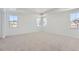 Bright bedroom with neutral carpeting and multiple windows at 15566 W Beloit Ave, Morrison, CO 80465