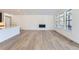 Bright living room with hardwood floors and a built-in fireplace at 15566 W Beloit Ave, Morrison, CO 80465