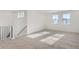 Bright loft area with large windows and neutral carpeting at 15566 W Beloit Ave, Morrison, CO 80465