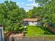 Aerial view of a home with a large backyard, mature trees, and a wooden deck at 4140 S Inca St, Englewood, CO 80110
