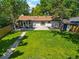 Lush backyard with a well-manicured lawn and mature trees, ideal for outdoor entertaining at 4140 S Inca St, Englewood, CO 80110