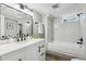 Elegant bathroom featuring marble tile, modern fixtures, and ample natural light at 4140 S Inca St, Englewood, CO 80110