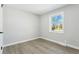 Bright bedroom with wood floors and a large window showcasing the outdoor view at 4140 S Inca St, Englewood, CO 80110