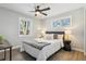 This charming bedroom features two windows, a ceiling fan, and stylish decor at 4140 S Inca St, Englewood, CO 80110