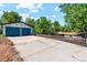 Large detached garage with dual doors, adjacent to the main house at 4140 S Inca St, Englewood, CO 80110