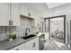 Updated kitchen with white cabinets, modern backsplash, and stainless-steel appliances at 4140 S Inca St, Englewood, CO 80110