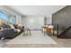 Cozy living room featuring a comfortable gray couch, fireplace accent wall, and modern decor at 4140 S Inca St, Englewood, CO 80110