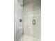 Close-up of a modern shower with glass doors, tile walls, and sleek black hardware at 4140 S Inca St, Englewood, CO 80110