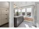 Modern bathroom with dual sinks, tile accents, and walk-in shower at 1626 Albion St, Denver, CO 80220