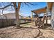 Backyard featuring patio, wooden fence, lawn, and rock landscaping at 7815 Conifer Rd, Denver, CO 80221