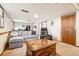 This basement space offers a plush sofa, recliner, and a vintage wooden coffee table at 7815 Conifer Rd, Denver, CO 80221