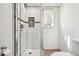 Modern bathroom featuring a glass-enclosed shower with white subway tile and mosaic accents at 7815 Conifer Rd, Denver, CO 80221