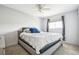 This bedroom features neutral walls, a large window, and a comfortable queen-sized bed with plush bedding at 7815 Conifer Rd, Denver, CO 80221