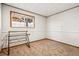 Bedroom features wood trim and neutral carpet at 7815 Conifer Rd, Denver, CO 80221