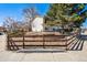 A charming home with a well-kept yard, decorative rock wall, and a classic wooden fence at 7815 Conifer Rd, Denver, CO 80221