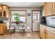 Bright kitchen features wood cabinets, sleek countertops, and a dining area with backyard views at 7815 Conifer Rd, Denver, CO 80221