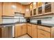 Stylish kitchen featuring stainless steel appliances and wood cabinets for a modern look at 7815 Conifer Rd, Denver, CO 80221