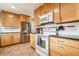 Kitchen boasts stainless steel appliances, wood cabinets, and seamless cooking experience at 7815 Conifer Rd, Denver, CO 80221